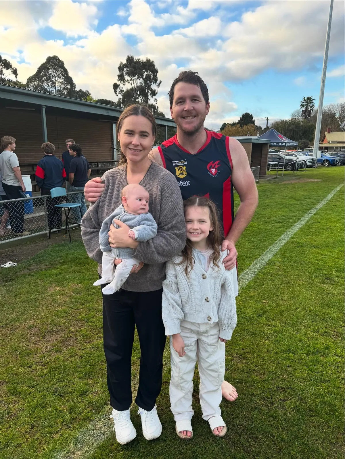A Uraidla player with his family on the oval boundary